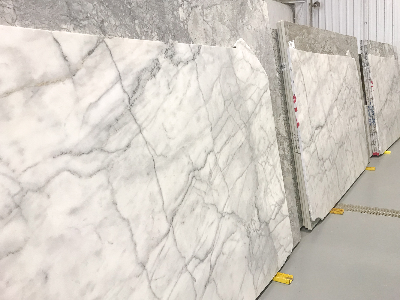 carrara marble countertop slabs in a warehouse