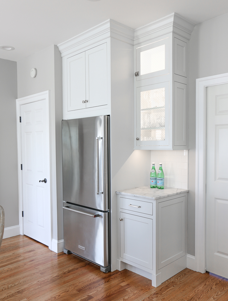 White kitchen cabinets with counter depth refrigerator