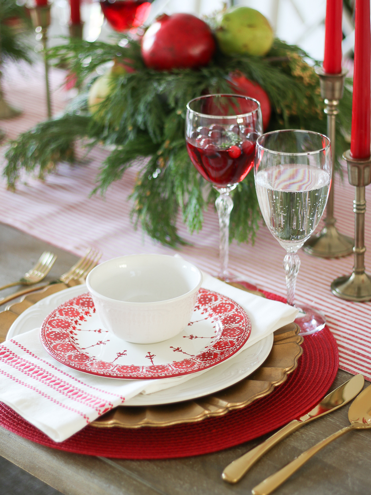 red and white christmas decor in the dining room, christmas table setting with fair isle dishes and gold accents