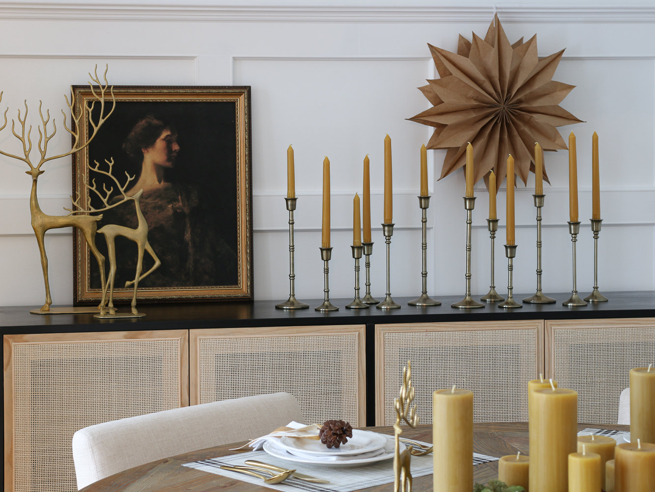 Christmas sideboard decor, brass reindeer, multiple brass candle holders with beeswax candles, cane cabinet