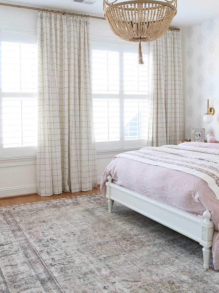 Mixing patterns with block wallpaper, windowpane drapes, floral block Studio McGee quilt, traditional loloi rug
