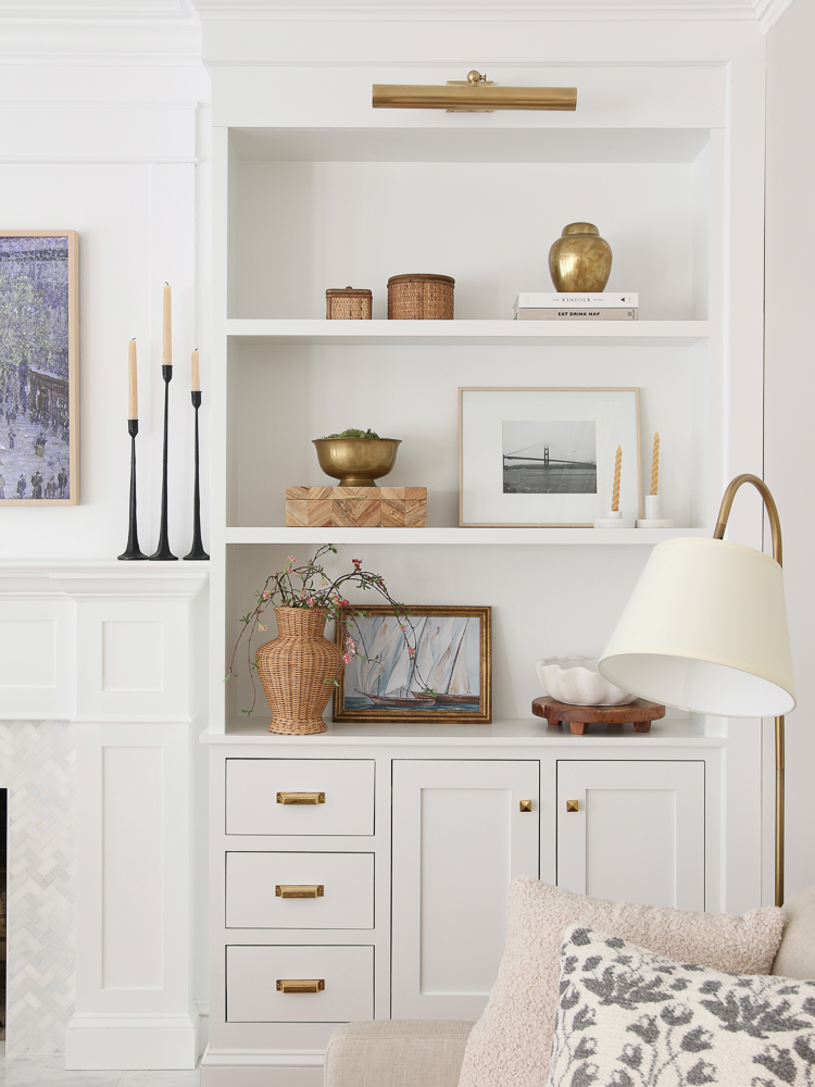 White paint color, fireplace builtins, shelf decor