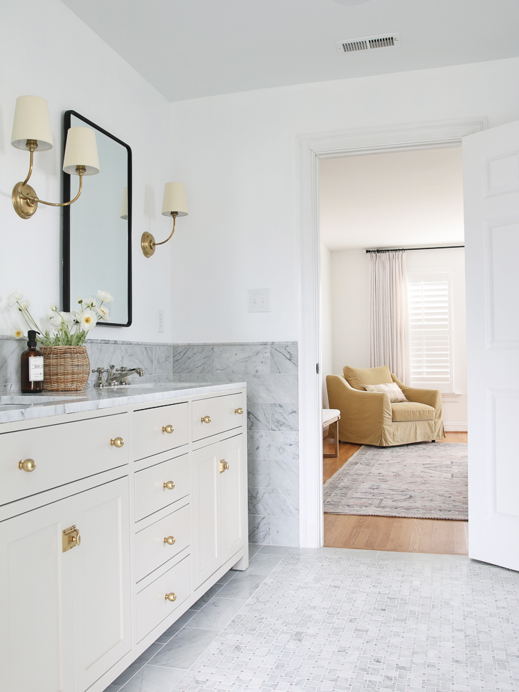 marble bathroom design, SW accessible beige vanity, new into adjacent bedroom with hardwood floors, window with drapes