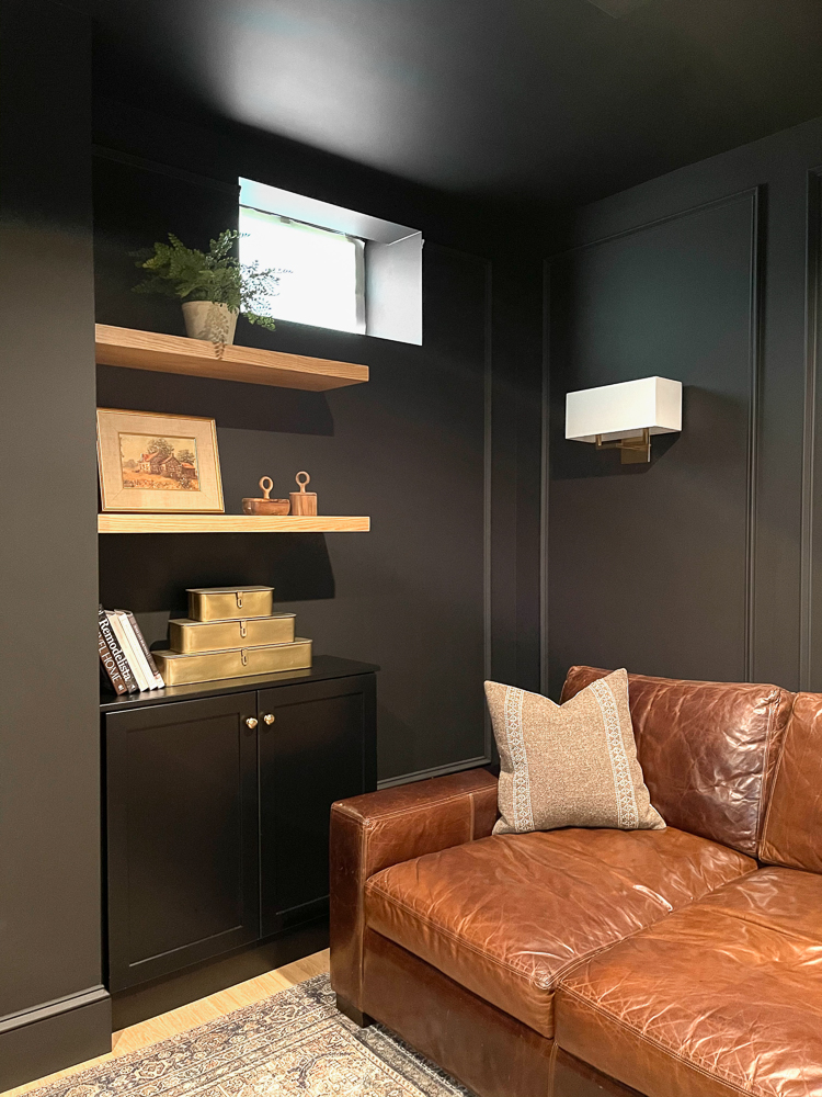 basement medial room painted all black a decorating trend someone might regret, SW Black Magic paint, leather sofa, shelf decor