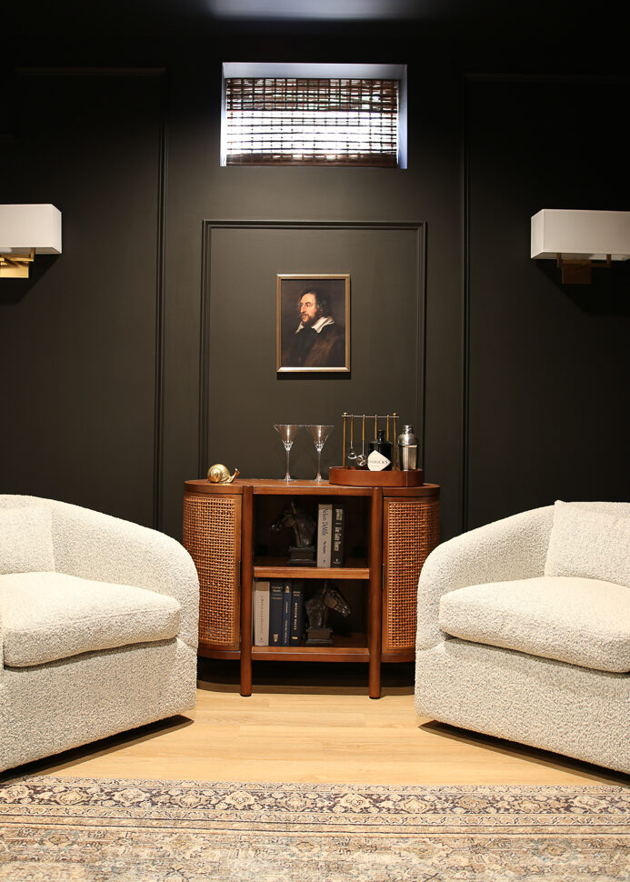 basement medial room painted all black a decorating trend someone might regret, SW Black Magic paint, two white boucle chairs flanking a small cane door cabinet