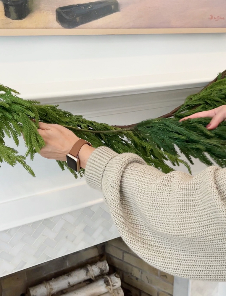 Add branches to your mantel garland for a full look
