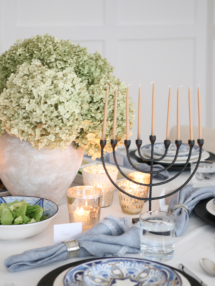 Set the Hanukkah table with a menorah centerpiece and a bouquet of hydrangeas, table decor with hanukkah colors