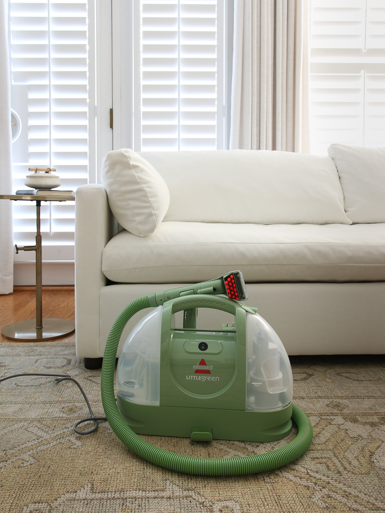 compact size of bissell little green machine on floor next to white sofa