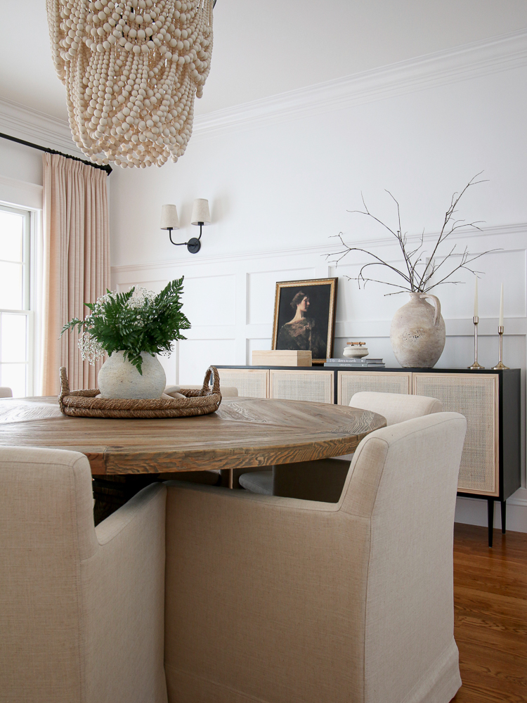 dining room refresh with round table, upholstered chairs, cane cabinet