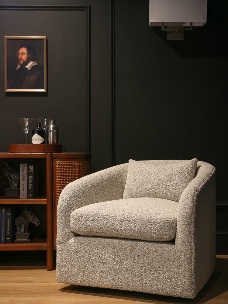 light boucle chair in room with contrasting black walls 