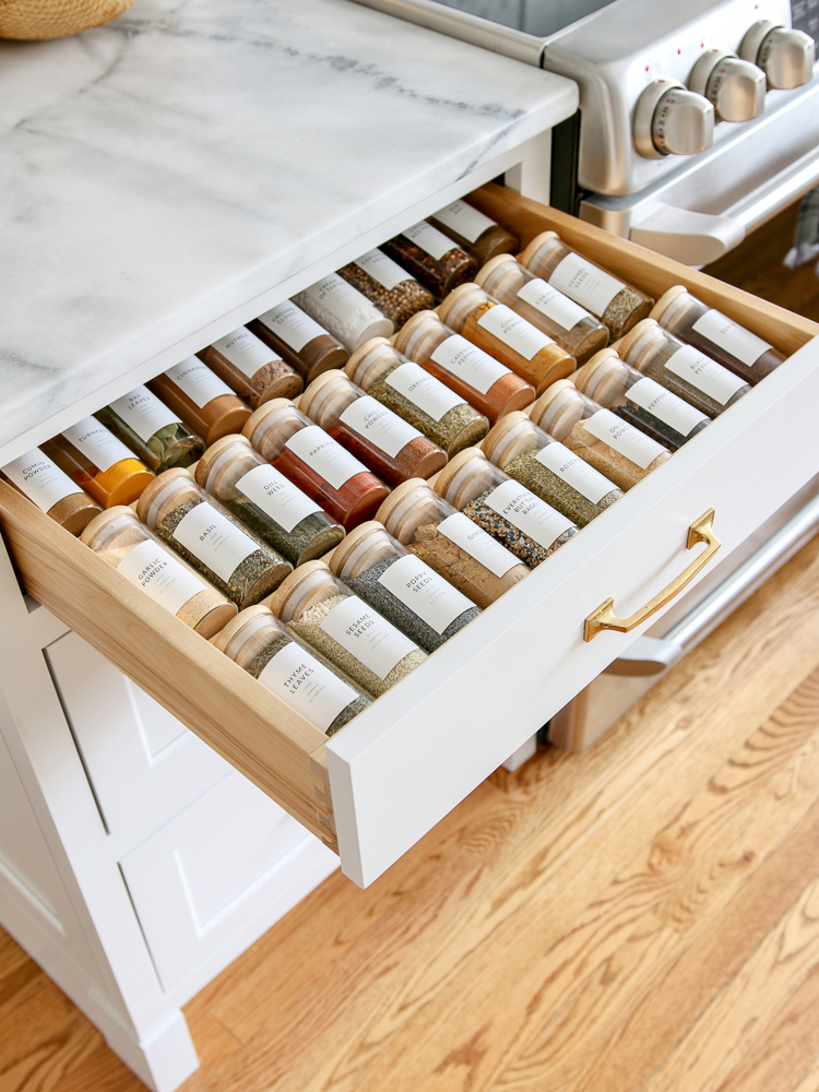 white kitchen spice drawer organization, drawer open showing organized spices in glass gars and minimalist labels, pantry cabinet and drawer organization ideas