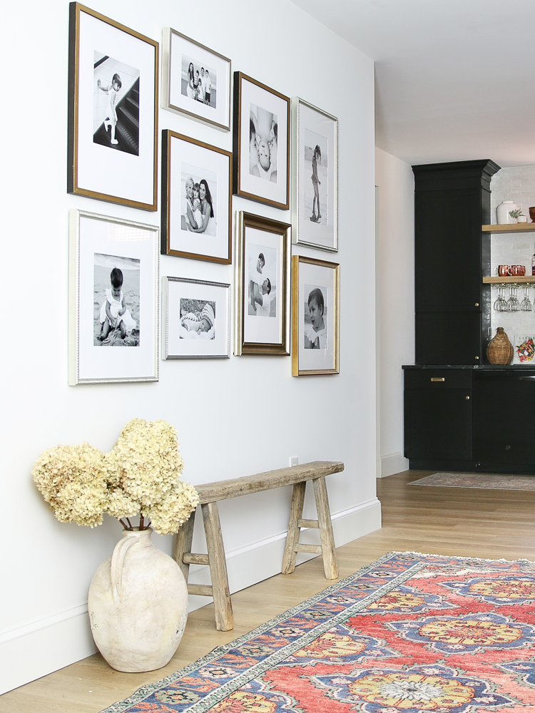 Photo gallery wall with vintage bench and artisan vase with hydrangeas