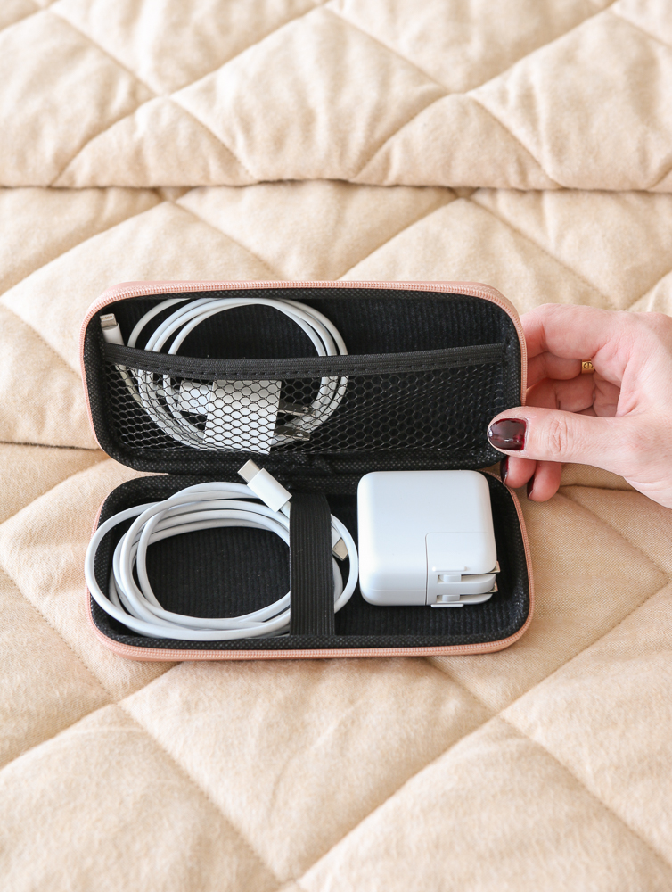 person showing travel essential cords organizer