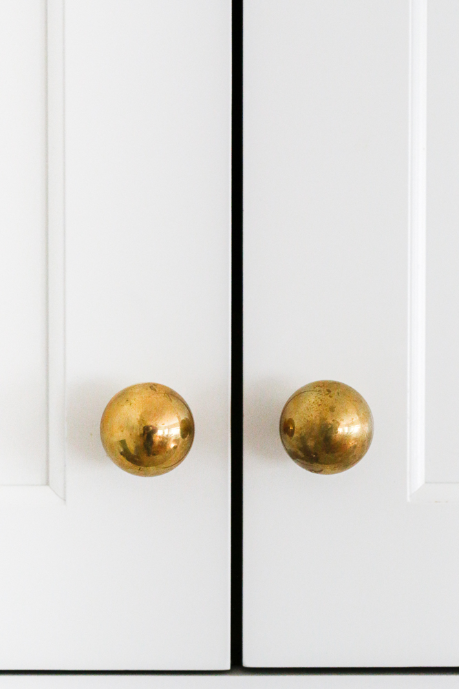 moderately used unlacquered brass cabinet hardware showing some patina
