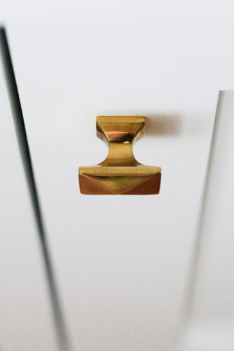 close up of square brass cabinet knob