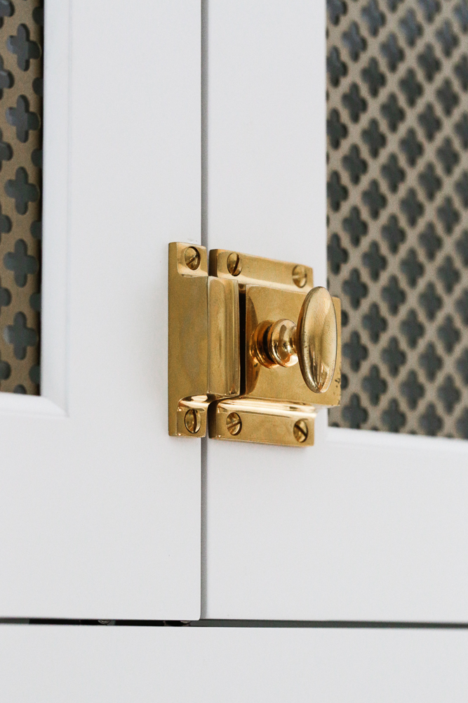 close up of brass cabinet door latch