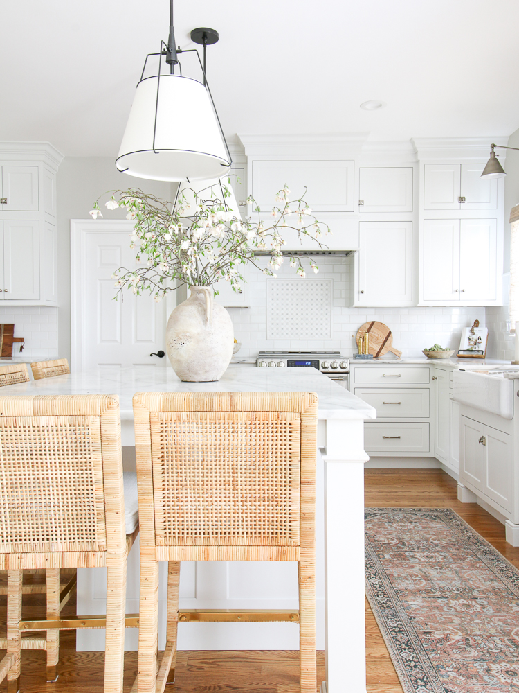 Serena and Lily Balboa counter stools, linen pendants over Carrara Marble countertops, classic white kitchen