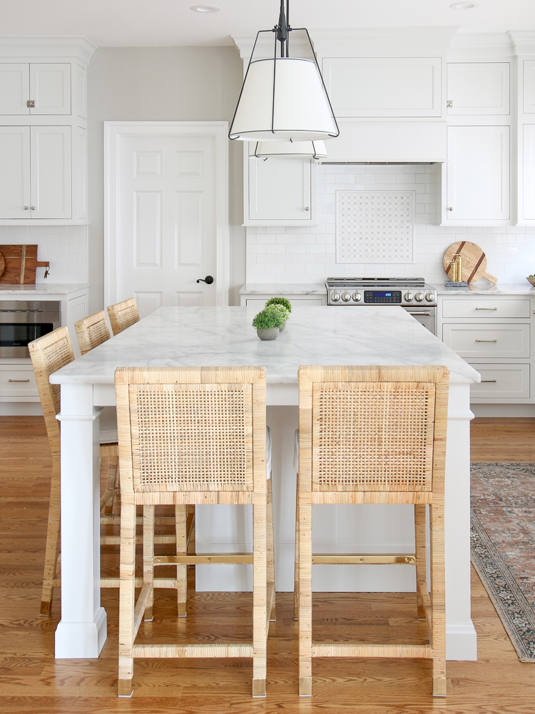 linen shade pendants over classic white kitchen island with Carrara Marble countertops