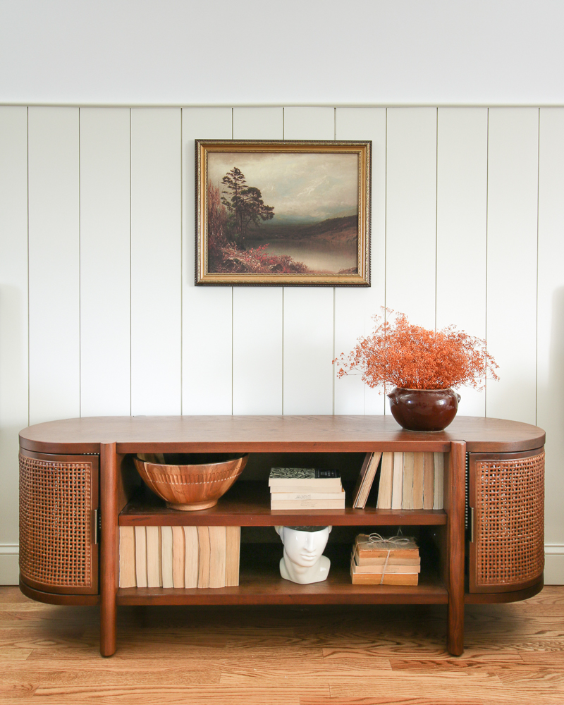 wood console table against a shiplap wall not found in cookie cutter home