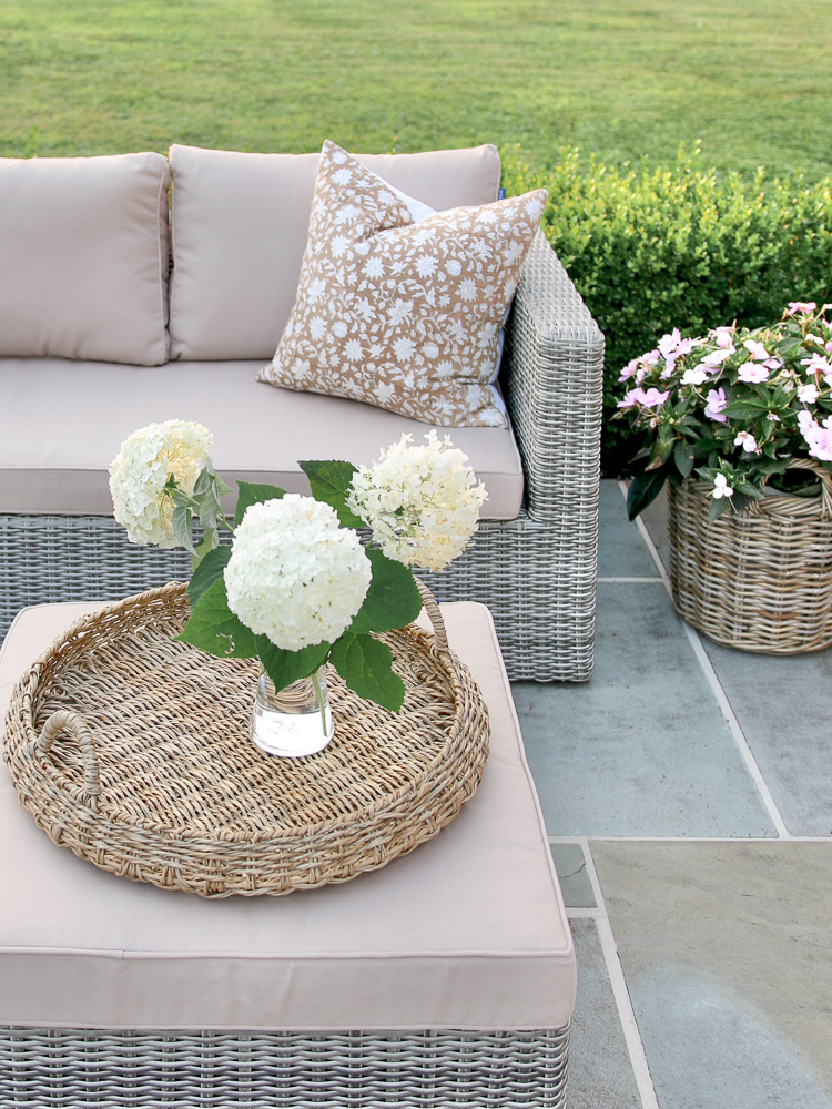 bluestone patio with cozy patio furniture and planter with flowers