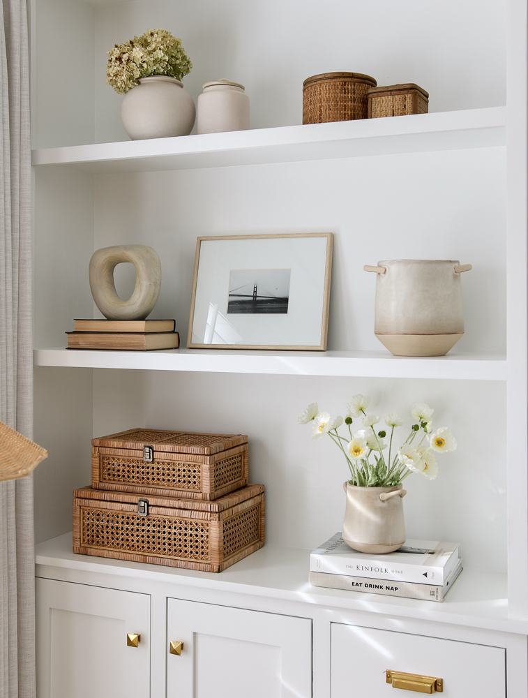 White open shelves styled with spring decorative objects. 