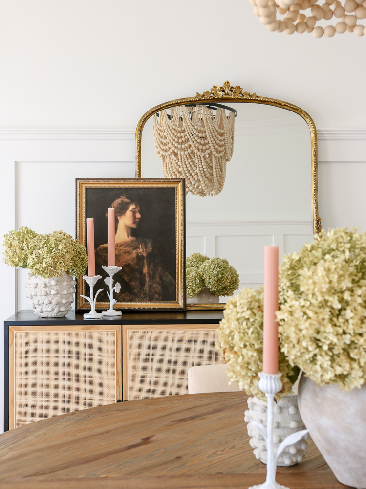 3 ft gleaming primrose mirror on black and woven sideboard with dried hydrangeas and candles