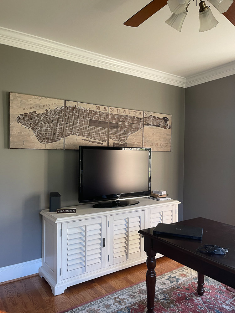 TV wall with white media cabinet and Manhattan sign above TV