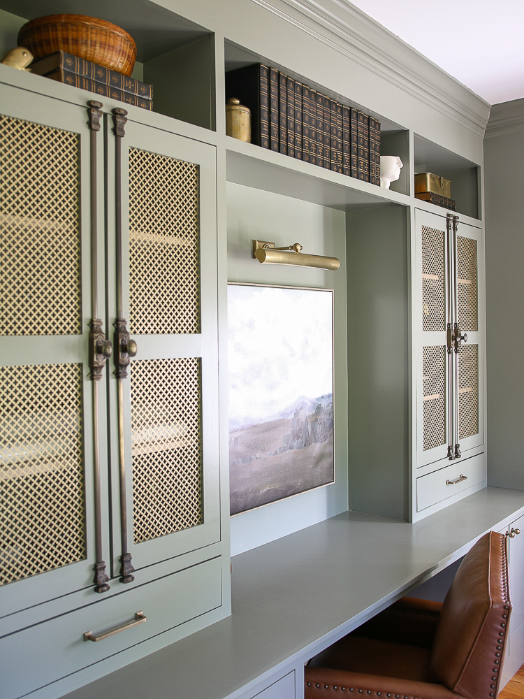 home office with built-in cabinet, antique brass hardware, picture light