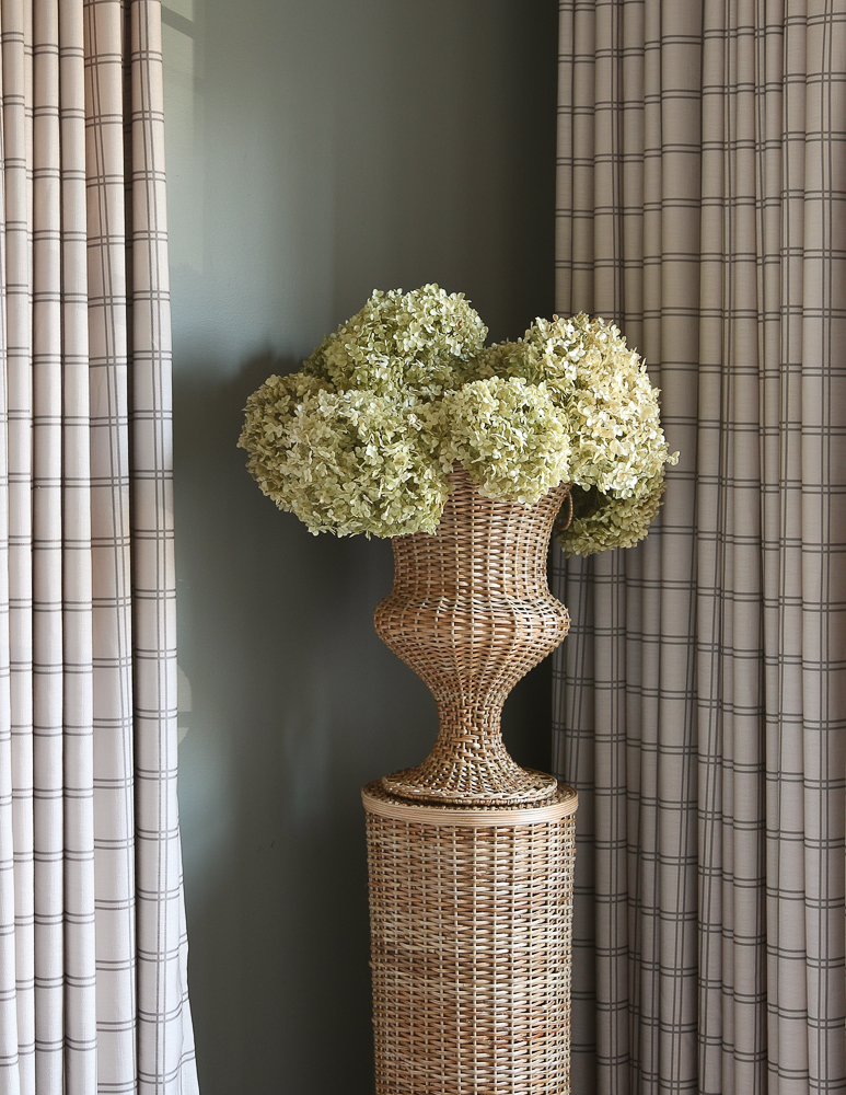 Woven pedestal and urn with large dried hydrangeas, walls painted BM storm cloud gray, drapes are Stefana Silber and TwoPages