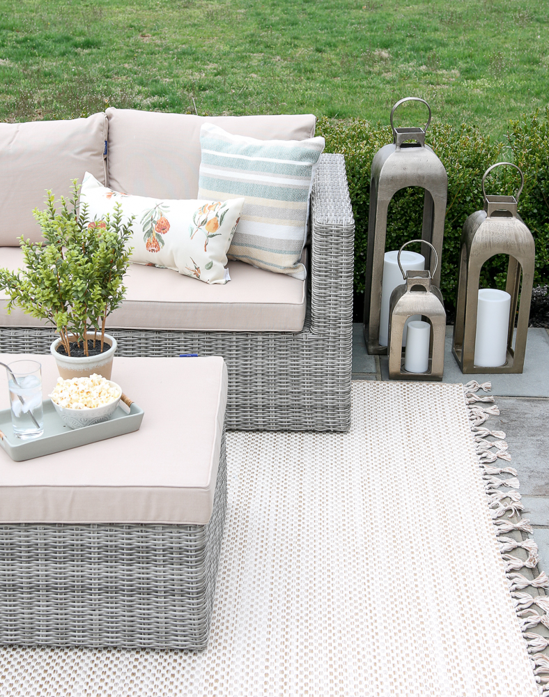 outdoor lounge furniture on bluestone patio with rug showing how a rug ties the space together