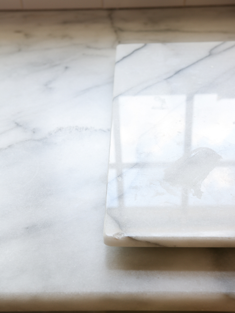 close up comparison of honed Carrara Marble and polished Carrara Marble