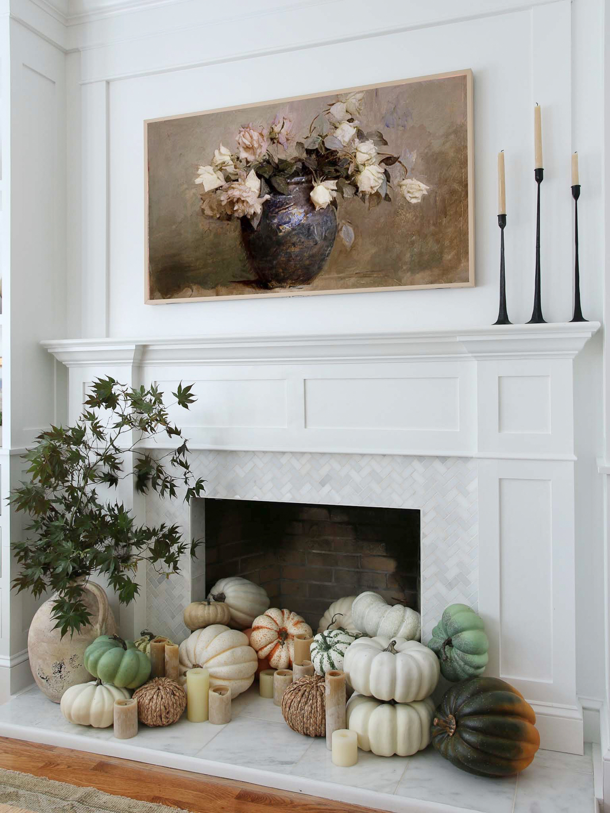 Fireplace with pumpkins at hearth and tv above