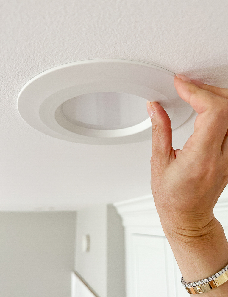 person attaching the recessed lights in a kitchen ceiling, led lights with adjustable color temperature