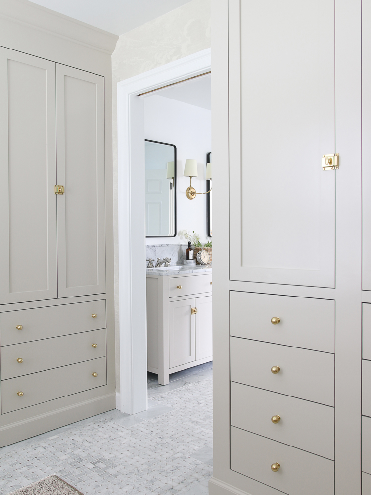 painted cabinet doors and drawers, painted IKEA furniture, accessible beige closet with brass hardware, marble tile floors