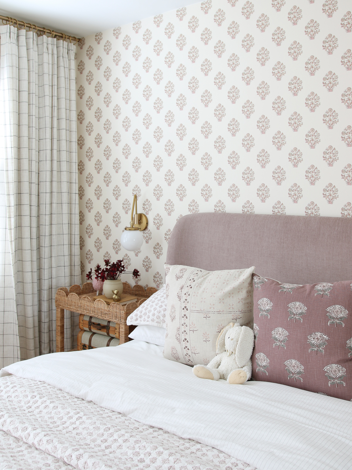 block print wallpaper, velvet headboard, vintage pink print bedding, rattan scalloped nightstands, windowpane drapes