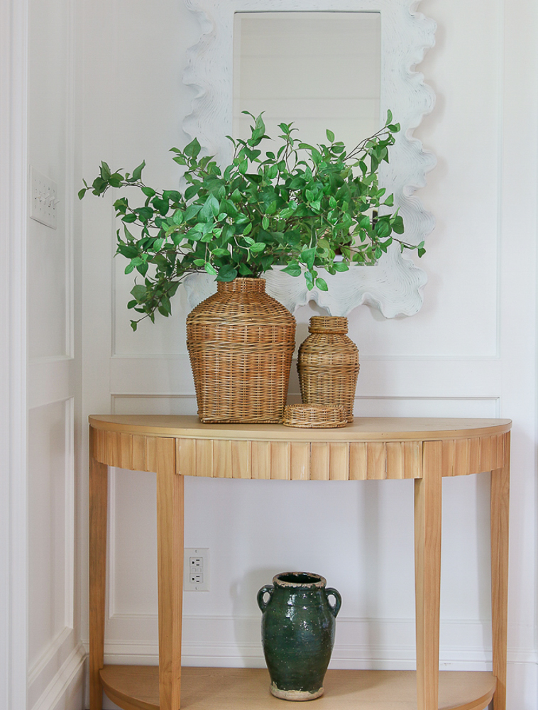 small natural entryway table styled with McGee and Co wicker jar set