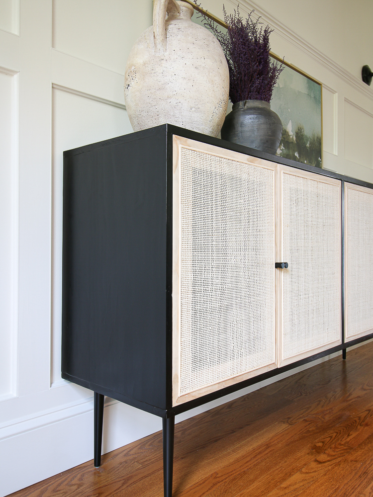Pottery Barn Dolores inspired cane cabinet, black cabinet frame with natural caning. Cabinet styled with artisan vases.