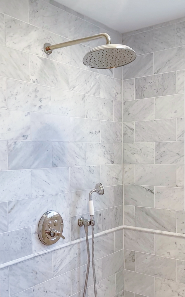 marble shower with polished nickel shower head, hand shower