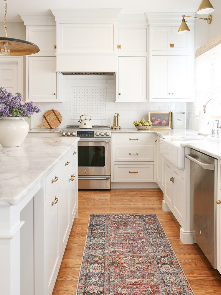 mixing metals in kitchen, classic white kitchen, inset cabinets, white subway tile, hardwood floors, brass cabinet hardware, stainless steel appliances
