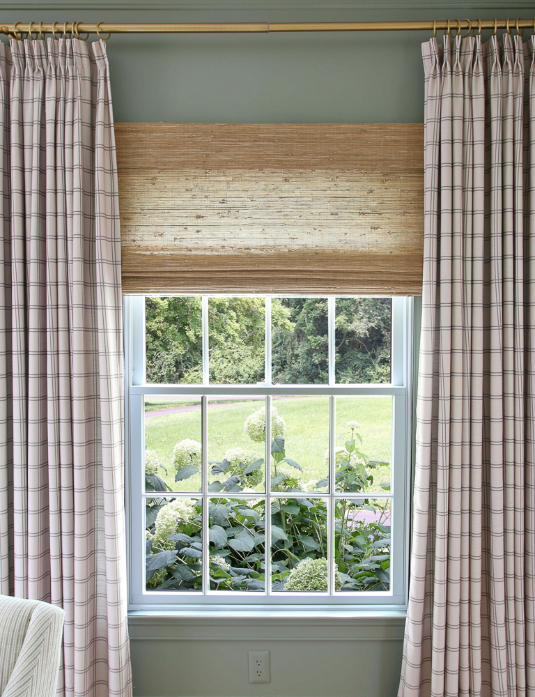 BM Storm Cloud Gray walls, Two Pages x Stefana Silber drapes, woven Roman Shade open, hydrangeas visible through window