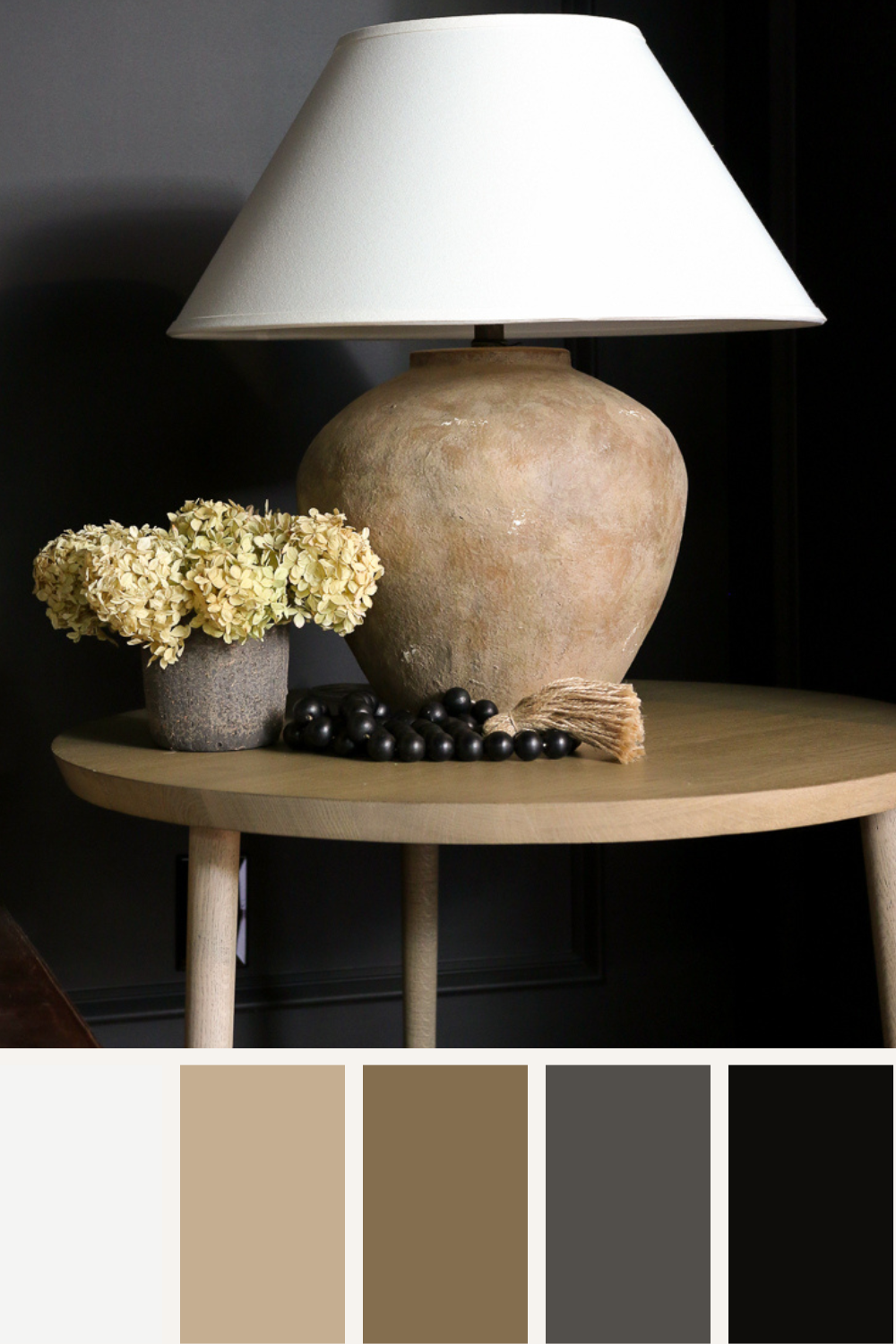 nature-inspired home decor, ceramic lamp styled on side table with dried hydrangeas and sting of black wooden beads, walls painted black