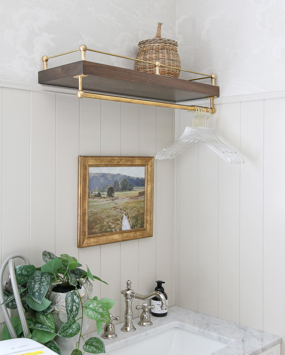 same laundry room with walnut floating shelf with DIY brass gallery rail on top and brass hanging pot rail underneath for handing clothes
