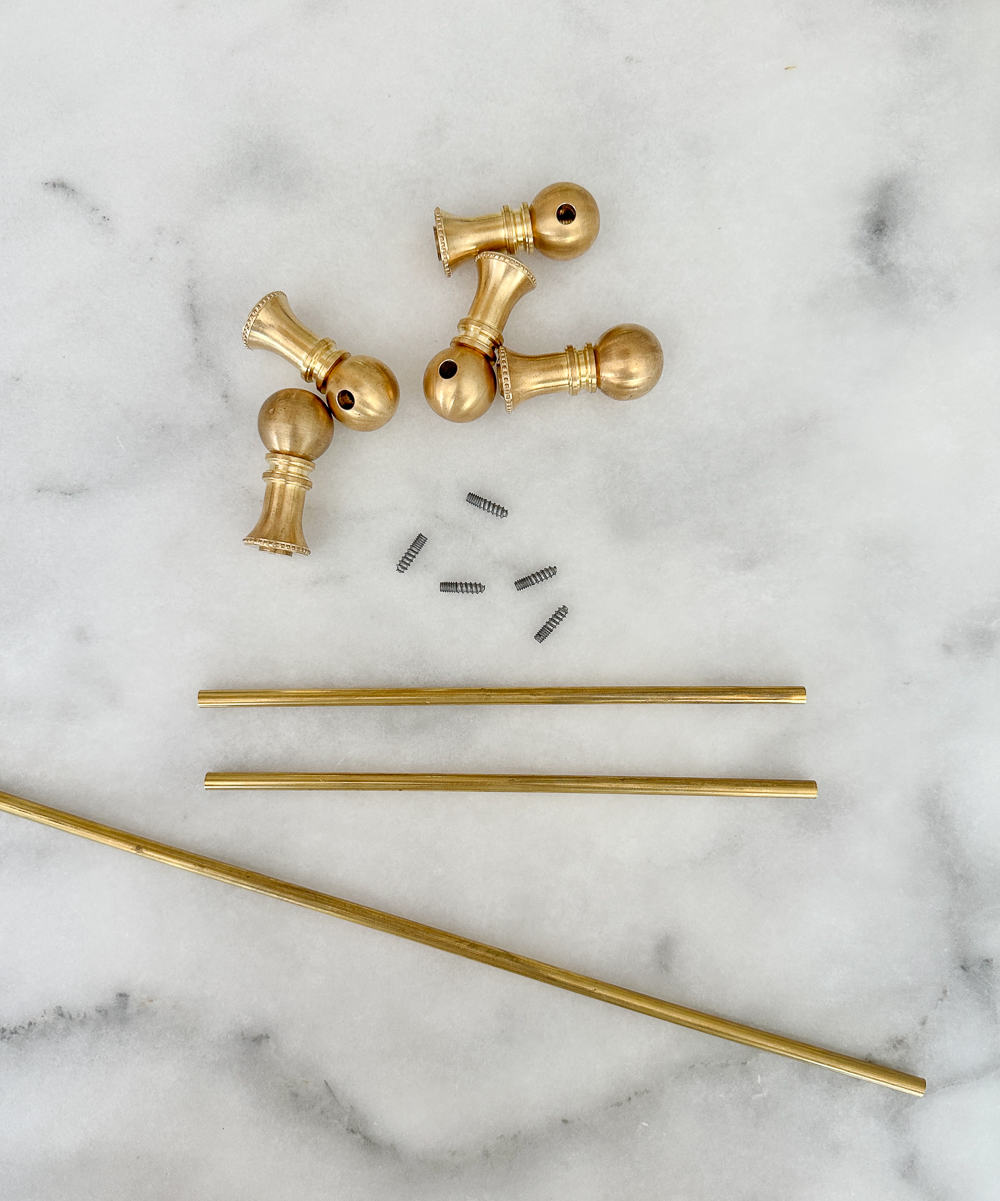 brass gallery rail materials and hardware on honed marble countertop