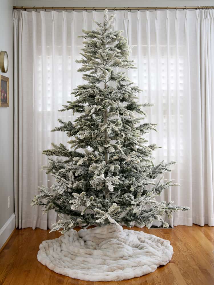 flocked aspen fir christmas tree with a fur blanket dIY tree skirt, lights are off