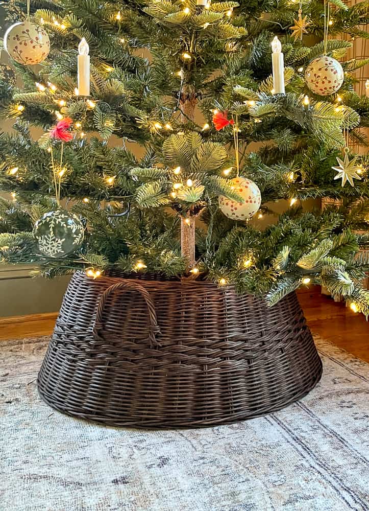 tree skirt alternatives,Dark brown wicker tree collar to cover the Christmas tree base, cloudpile lolol rug, Aspen fir tree with vintage candle ornaments