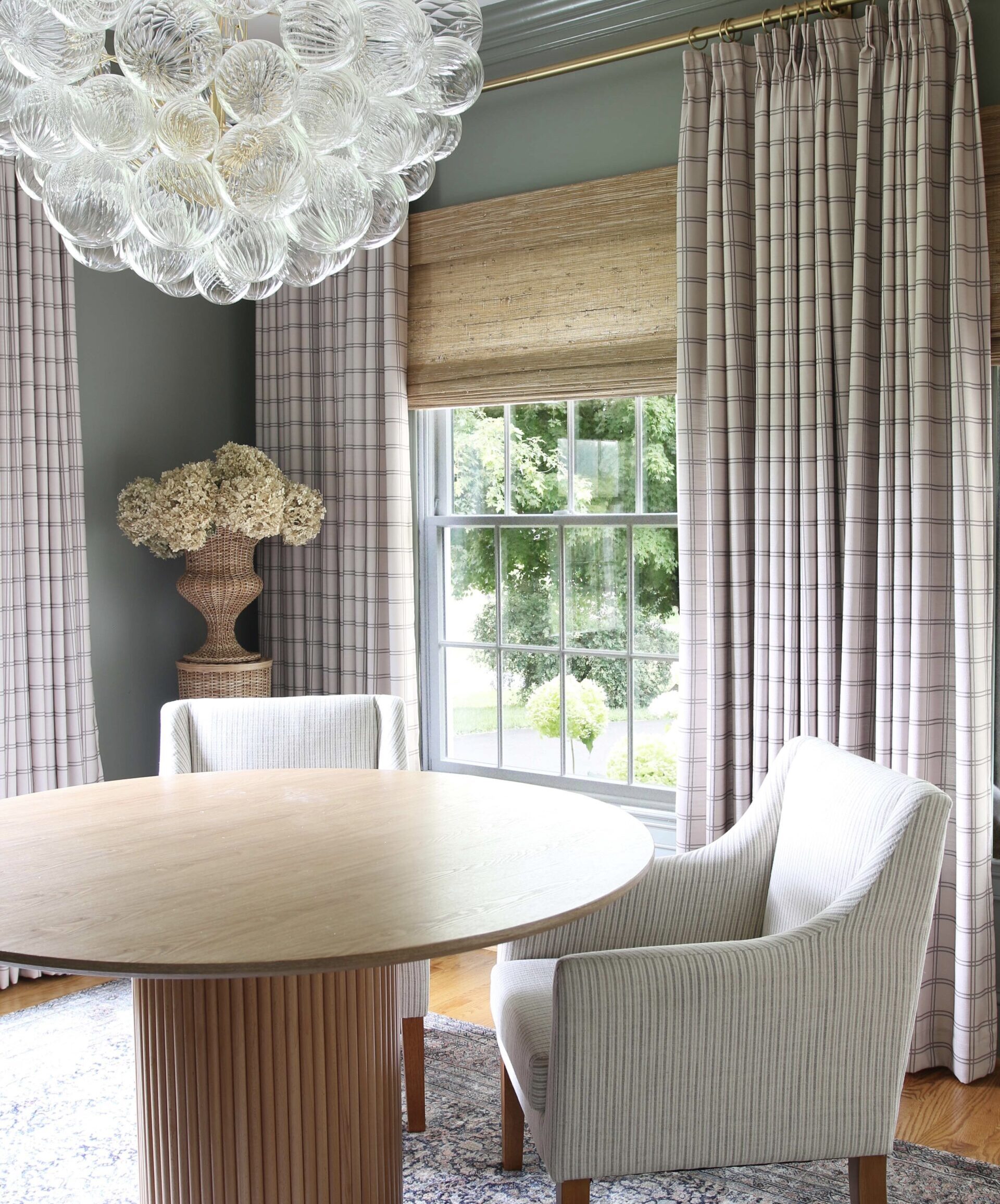 home office with drapes, woven shades, bubble light chandelier, walls and trim painted the same color demonstrating decorating trends someone might regret