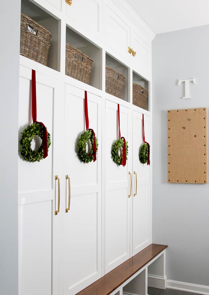hang wreaths on cabinet doors, mudroom built-in cabinets, red ribbon used to hang wreaths from the doors