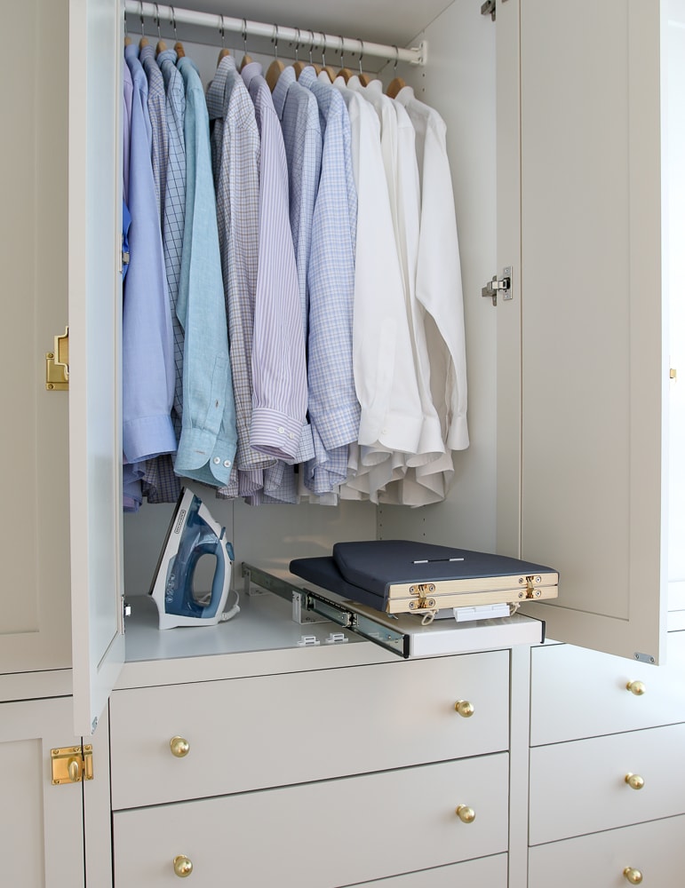 clothes closet with small retractable ironing board