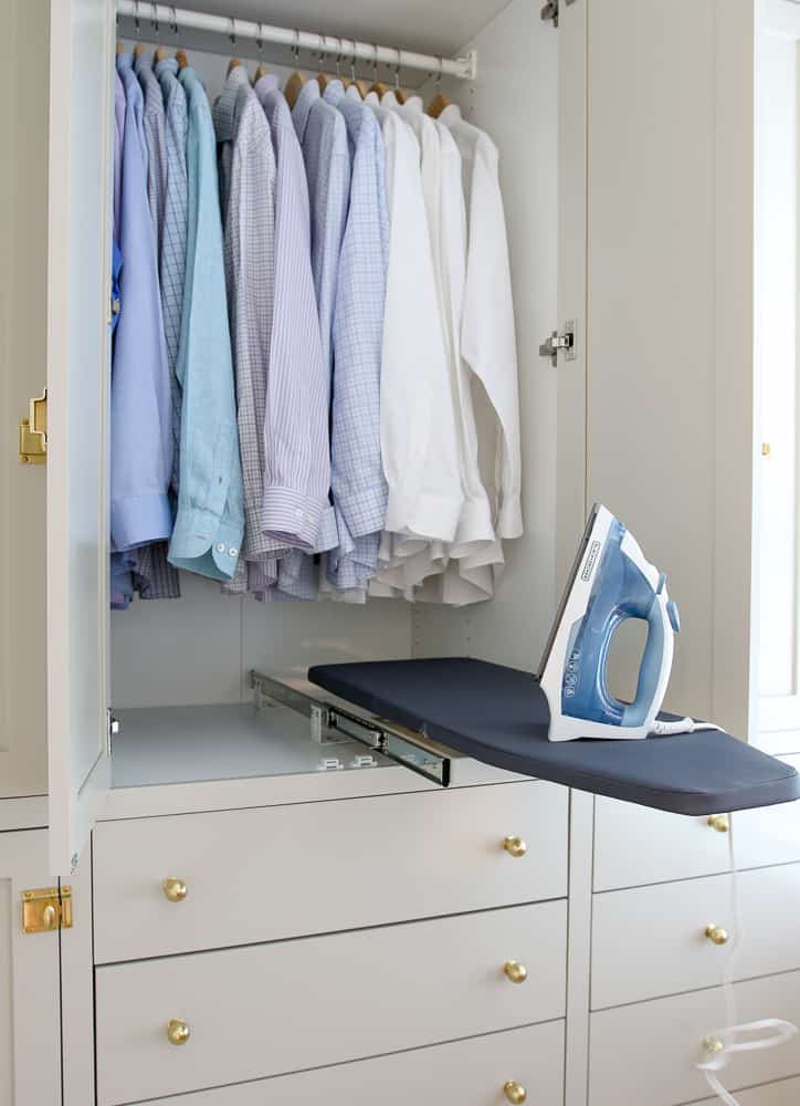 clothes closet with small retractable ironing board fully extended