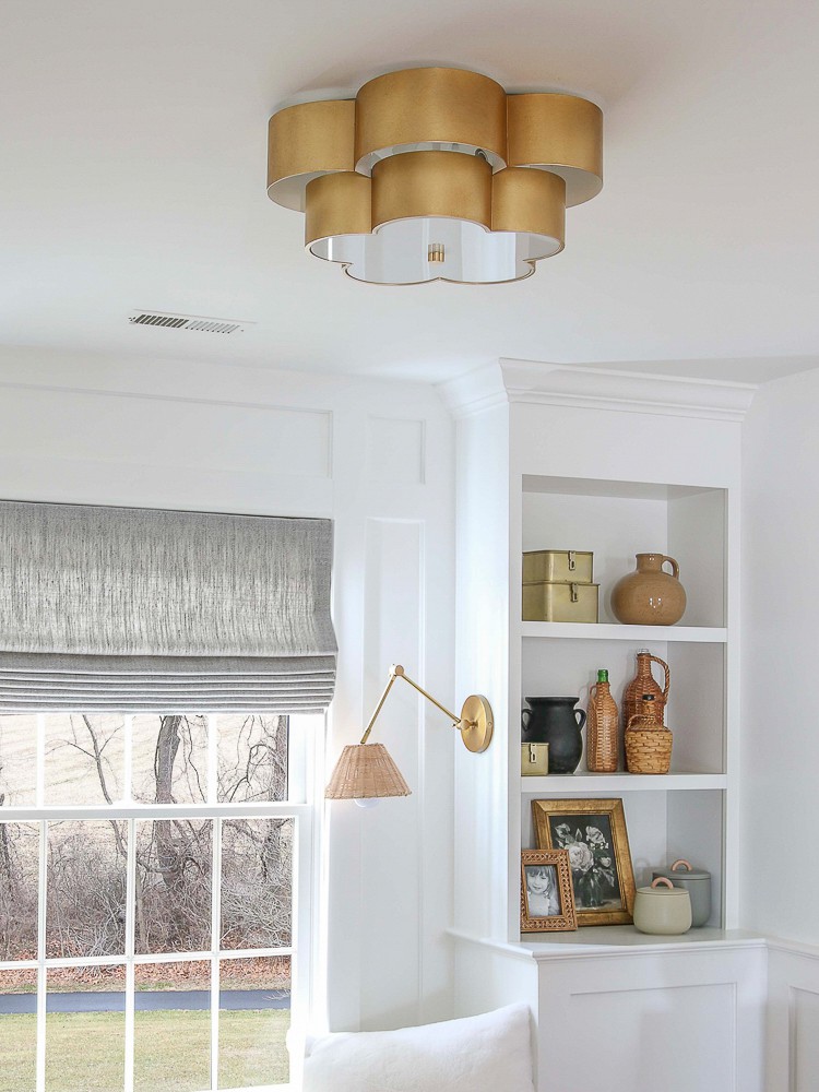 room refresh by replacing boob light with modern light fixture, white walls with builtin shelves, woven shade on window, shelf decor, 